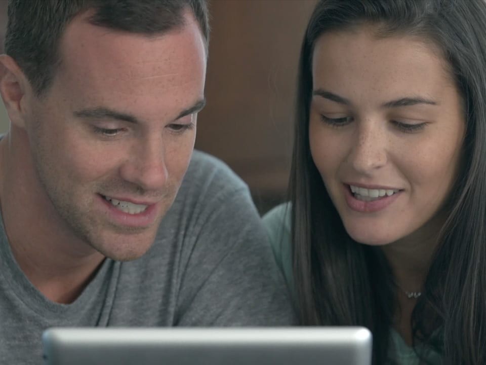 a couple looking at an iPad
