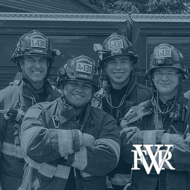 four smiling firefighters in full gear