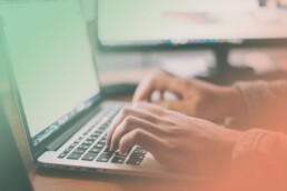 a person typing on a MacBook